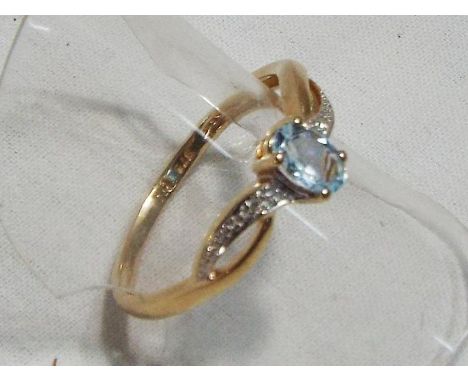 A lady's yellow metal ring stamped 375, set with topaz and diamonds, approx weight 1.58 gm (all in) size P