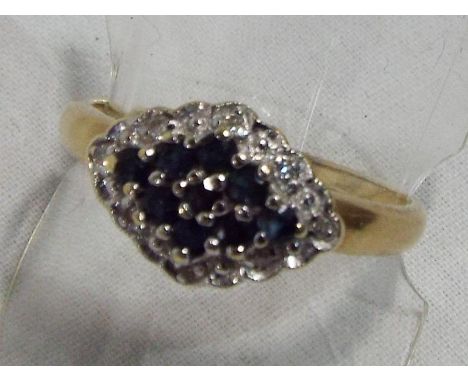 A lady's sapphire and diamond hallmarked 9 carat yellow gold cluster ring, approx weight 2.44 gm (all in) size P + 1/2, boxed