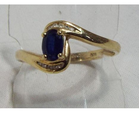 A lady's hallmarked 9 carat yellow gold ring set with sapphire and diamond, approx weight 1.82 gm (all in) size Q