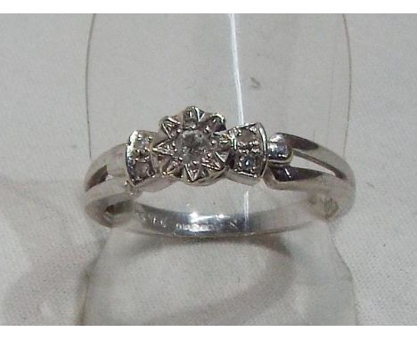 A lady's hallmarked 9 carat white gold ring set with diamonds, approx weight 2.8 gm (all in) size N + 1/2
