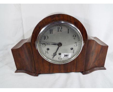 A mahogany cased Westminster quarter chiming mantel clock, silvered dial behind chrome bezel, Arabic numerals, movement marke