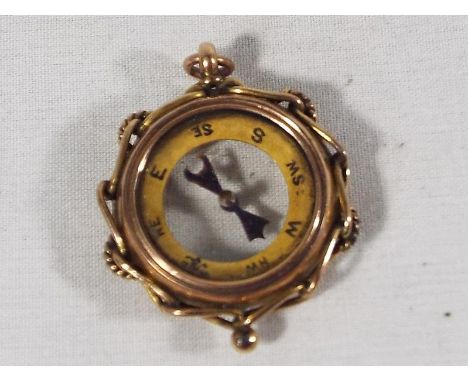 A pendant in the form of a hallmarked 9ct gold cased compass, 2.5cm (diam) approx weight 7.44 grams (all in)