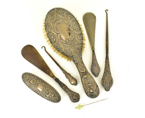 A six-piece hallmarked silver dressing table set comprising hairbrush, oval glass box with silver lid, two button hooks with 