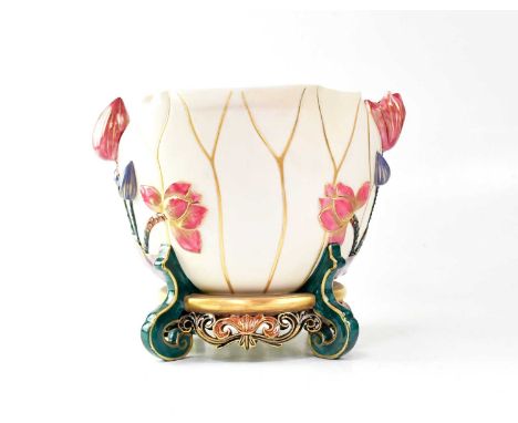 ROYAL WORCESTER; a cream ground chassepot decorated with raised flowers and gilt detailing, on a base with four scroll suppor