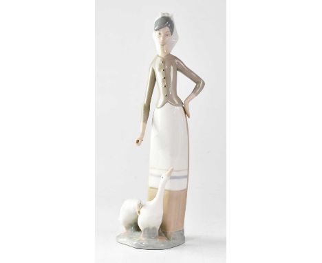 LLADRÓ; a figure group of a young lady feeding two geese, height 28cm and a figure of a young lady, 'Ingénue', in original bo
