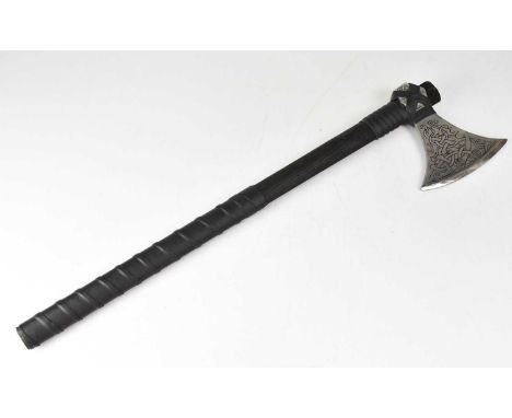 A decorative re-enactment battle axe with incised Celtic knot decoration and leather-bound black ash handle, overall length 7