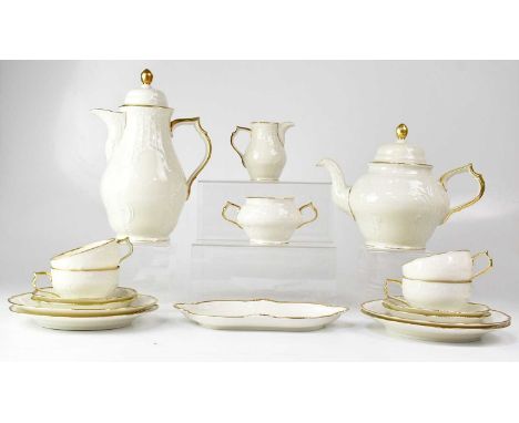 A Rosenthal porcelain part tea service in cream and gilt with embossed decoration comprising teapot, milk jug, cups, saucers,