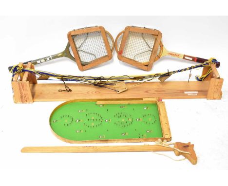 A vintage Bagatelle board, length 62cm, two vintage tennis racquets by Rucanor and Superstroke, each with Dunlop racquet clam