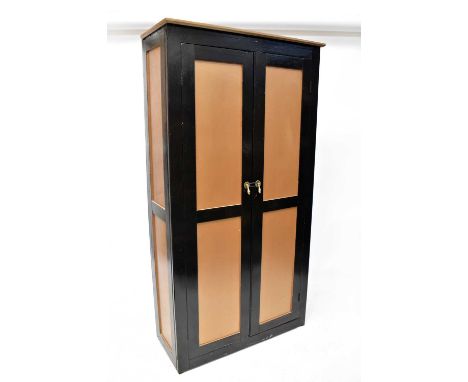 An early 20th century pine shallow hall cupboard, painted in gold and dark brown, with moulded cornice above pair of panelled