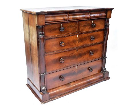 A Victorian mahogany Scotch chest, with three cushion drawers above two short and three long drawers, flanked by carved cabri