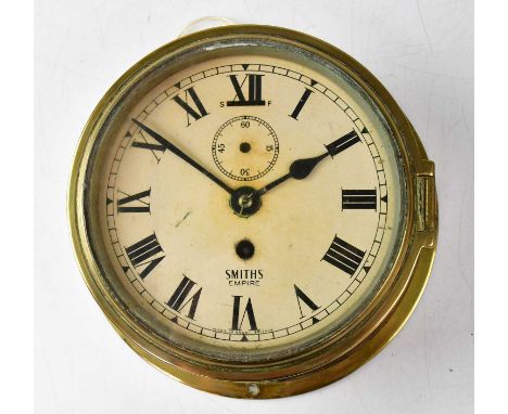 A Smith's Empire brass porthole clock, the dial set with Roman numerals and outer minute track, with subsidiary dial, lacking