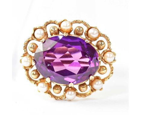 An amethyst and seed pearl brooch, the claw set central amethyst within a border of seed pearls and gold beads, in an open fr