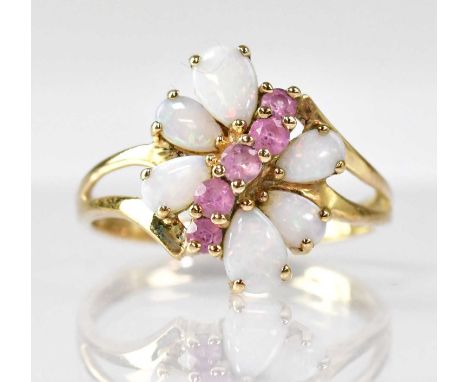 A 9ct gold amethyst and opal ring, with a central diagonal line of five claw set amethysts, flanked by three claw set pear-sh