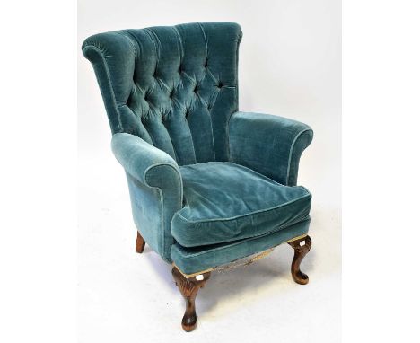 A Georgian-style button back armchair on carved cabriole legs, upholstered in blue velour, height 86cm.