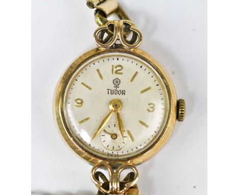 TUDOR; a 9ct gold cased ladies' manual wind wristwatch with 15 jewel movement, the silvered dial set with Arabic numerals, ba
