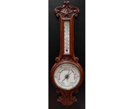A Victorian carved oak aneroid banjo barometer/thermometer, with 7.5" enamelled dial, height 81cm.Condition Report: - Please 
