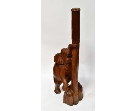 A large carved wooden lamp stand featuring an elephant with trunk wrapped around post, with hole to the centre of the post fo