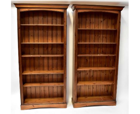 A pair of waxed pine tall bookcases of six shelves, on plinth base, each 200 x 98 x 33cm (2).Condition Report: Scratches, kno
