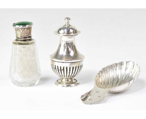 A hallmarked silver shell-shaped caddy spoon, a hallmarked silver pepperette, combined approx. 1.3ozt and a glass scent bottl