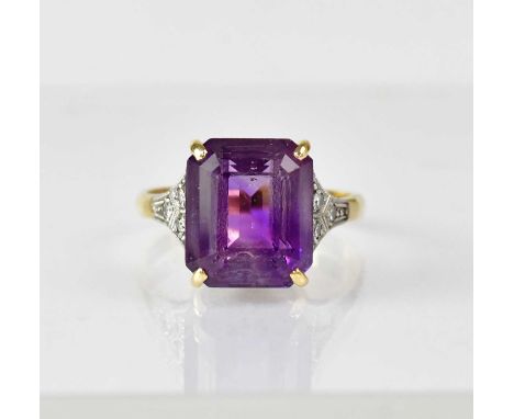 An 18ct gold ring with claw set square cut amethyst, 1 x 1.3cm, and three tiny claw set diamonds to each platinum shoulder, s