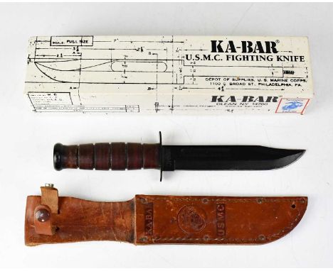 KA-BAR; a boxed U.S.M.C. fighting knife with 6 3/4" clipped fullered blade, stamped to the hilt 'KA-Bar Olean, N.Y.' and furt