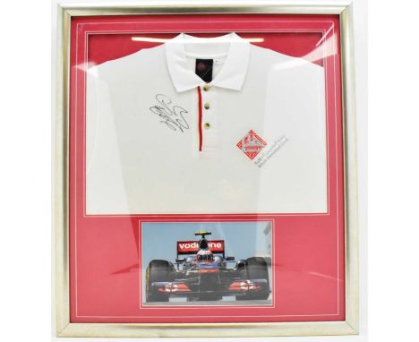 JENSON BUTTON; a signed shirt from the Bahrain International circuit, with colour action shot below, framed and glazed.Condit