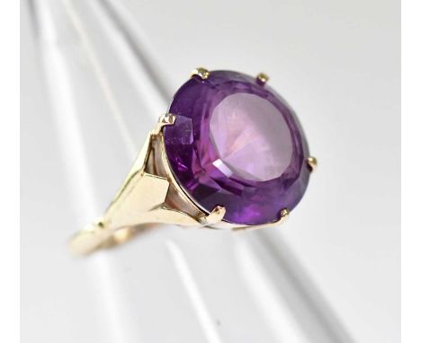 A 9ct gold dress ring with large amethyst-coloured stone, size K, approx. 4.4g.
