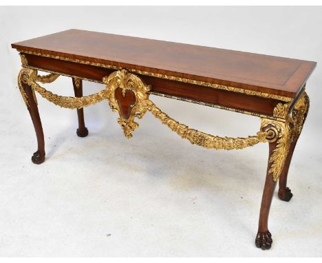 A Louis XV style mahogany console table with cross banded rectangular top above gilt painted and carved frieze of swags and a