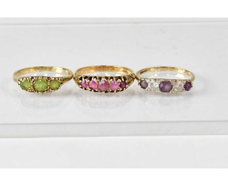 Three 9ct gold gem set dress rings, comprising a three-stone peridot ring, size P, an amethyst and white stone ring, size P, 