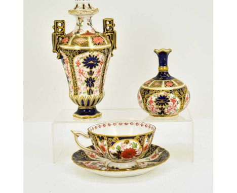 ROYAL CROWN DERBY; three Imari decorated items comprising a twin-handled vase and cover, height 20cm, a globe-shaped small ca
