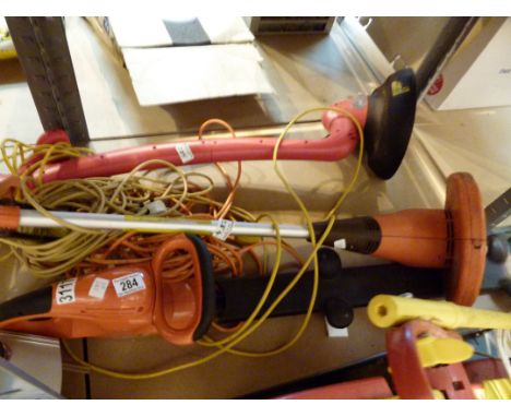 Two electric garden strimmers and an electric chainsaw