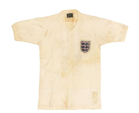 England: A Bukta England, match worn white, v-neck home shirt. Worn by Sir Bobby Charlton in an unknown England fixture betwe