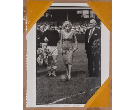 Football: An interesting black and white photograph of Marilyn Monroe kicking a football at the celebratory match between Hap