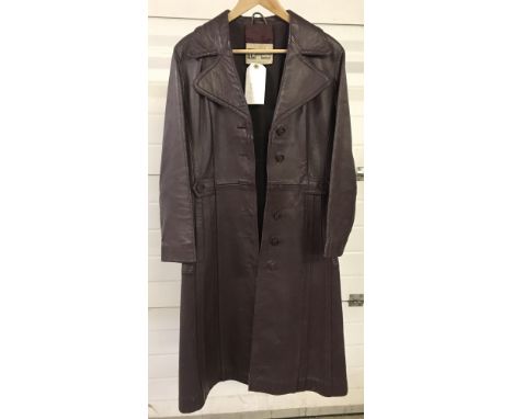 A vintage 1970's ladies maroon leather 3/4 length coat by Suede &amp; Leathercraft Ltd. Pleat and button detail to front, fro
