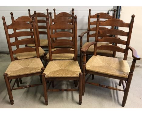 A set of 8 rush seated ladder back farmhouse dining chairs, comprising 6 chairs and 2 carvers. With turned detail to front le