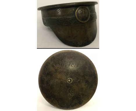 An unusual WW1 trench art brass peaked cap made from a German shell case. Mounted with an Imperial German button (as a badge)