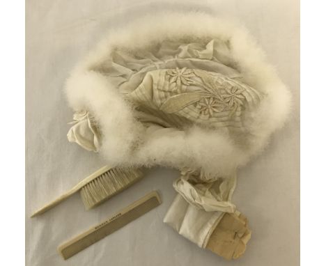 A Victorian silk and white fur baby's bonnet with embroidered floral decoration and lace trim. Together with a baby's bone br