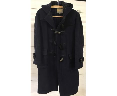 A vintage Navy blue wool duffel coat by Gloverall, London. With tartan lining and front pockets. 34" chest.