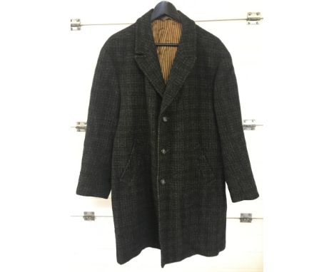 A men's vintage fully lined wool coat in a check type pattern. Front button fastening and 2 front pockets. 