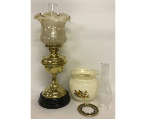 A large vintage brass oil lamp on ceramic base. With embossed lustre finish fluted shade. Complete with chimney. Together wit