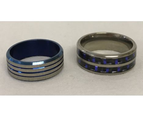 2 x titanium wedding bands / rings in different styles. One with blue channel set decoration, signed Spikes Titanium, size S.