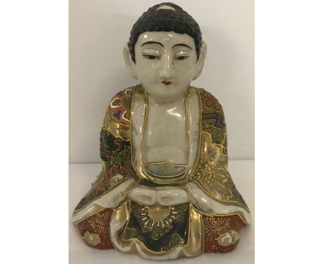 A Kutani ceramic Buddha. Signed to base. 13.5 cm tall.