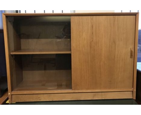 A retro light teak sliding door sideboard with one glazed panel and one wood. Interior wooden adjustable shelving to both sid