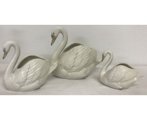 3 unboxed Nao swan posy vases in graduated sizes.  