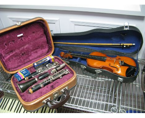 A Rosehill Five Piece Clarinet, in a fitted plush lined cased and a XX Century violin, one piece back, with bow and a Skylark