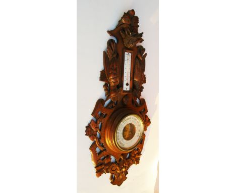 Barometer and Thermometer carved frame with a wolf head and gamebirds.