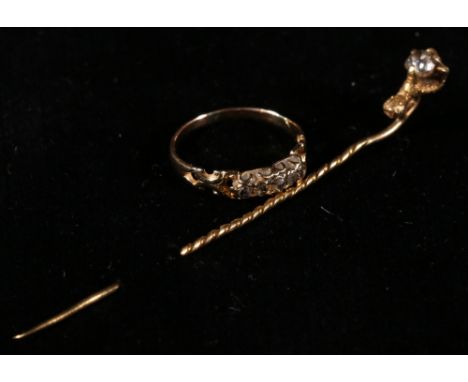 Unhallmarked gold tie pin, the finial in the form of a claw holding a solitaire diamond and a five stone ring (2)