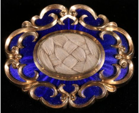 Victorian gilt metal and blue guilloche enamel mourning brooch of oval form with central plait of woven hair, unmarked, 4.5cm