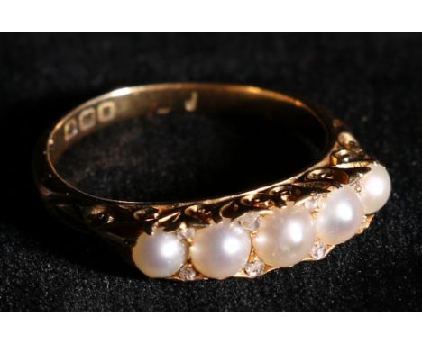 Victorian eighteen carat gold five stone pearl ring, in a scroll setting, hallmarked, 5g gross. CONDITION REPORT: Ring appear