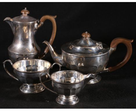 Silver four piece tea service, of circular form comprising a teapot, 14cm. hot water pot, 19cm, sugar, 8cm and cream jug, 7cm